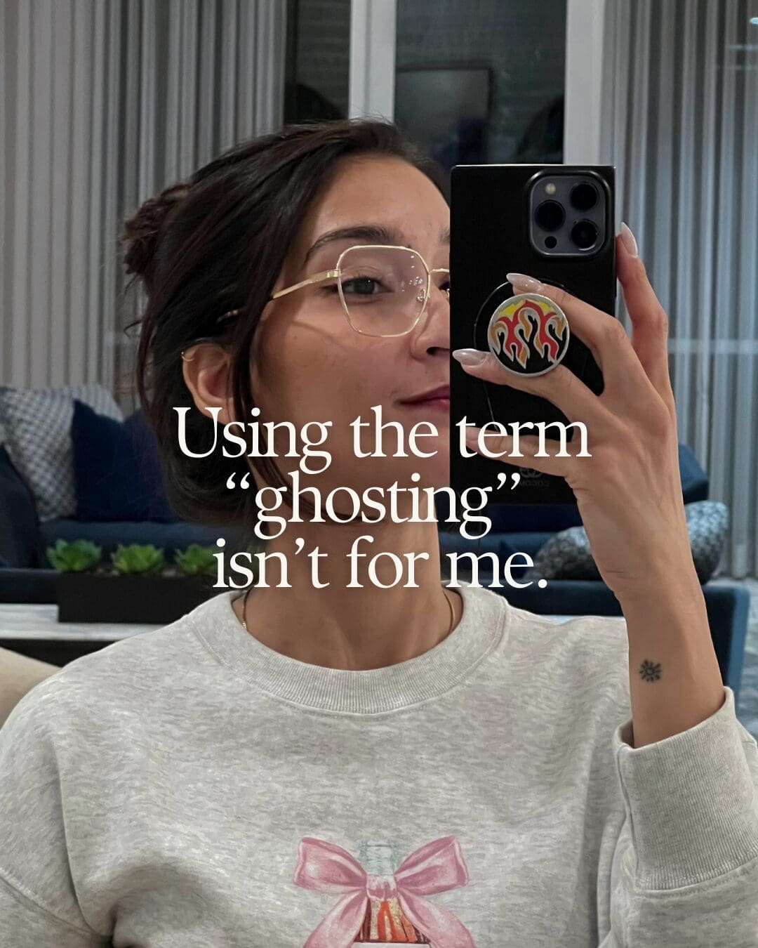 Girl taking selfie in mirror with black iPhone, overlaid text says Using the term "ghosting" is not for me