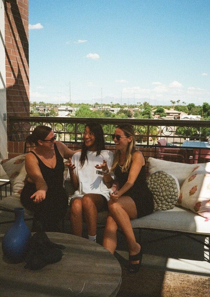 Three women on an outdoor couch talking at Thrive Coworking for Women in Gilbert, AZ
