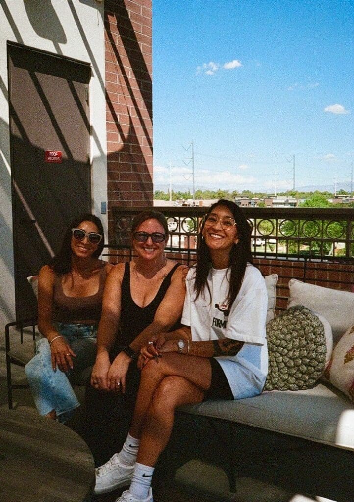 Three women similing on a couch at Thrive Coworking for Women in Gilbert, AZ
