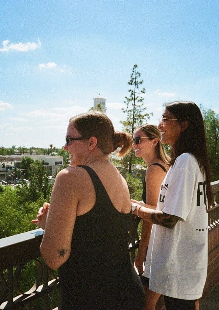 Three women looking over a balcony railing at Thrive Coworking for Women in Gilbert, AZ