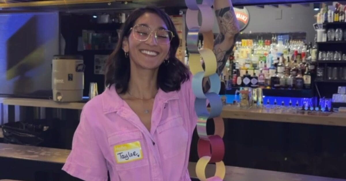 girl holding a paper chain at craft club in downtown phoenix